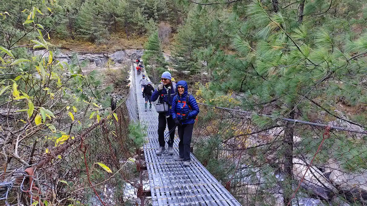 crossing suspension bridge in annapurna conservation area